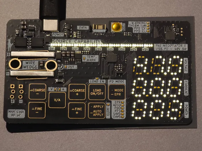 The front of the card with every light on: the capability bar, the voltage, current and power digits, and the status and mode lights